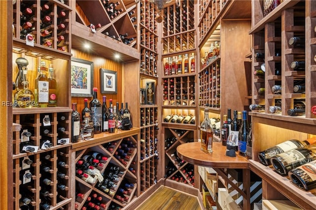 wine cellar featuring wooden walls and hardwood / wood-style floors