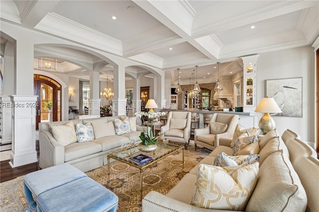 living room with dark wood-type flooring, coffered ceiling, crown molding, beam ceiling, and decorative columns