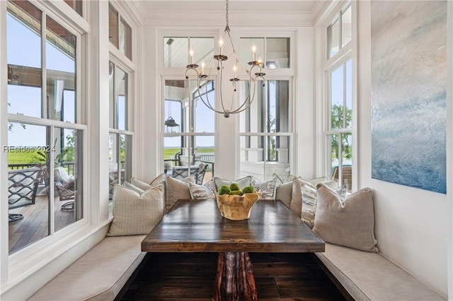 sunroom with breakfast area, a wealth of natural light, and an inviting chandelier