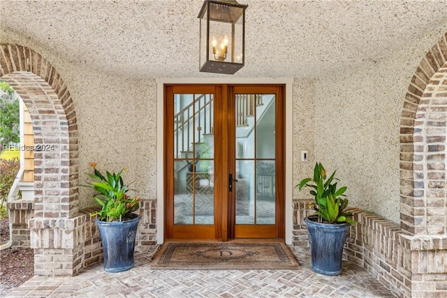 view of exterior entry featuring french doors