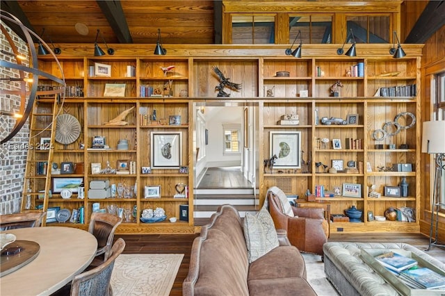 living area featuring hardwood / wood-style flooring, wood ceiling, and beam ceiling