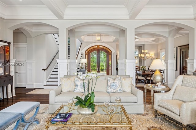 living room with crown molding, hardwood / wood-style flooring, beam ceiling, coffered ceiling, and a notable chandelier