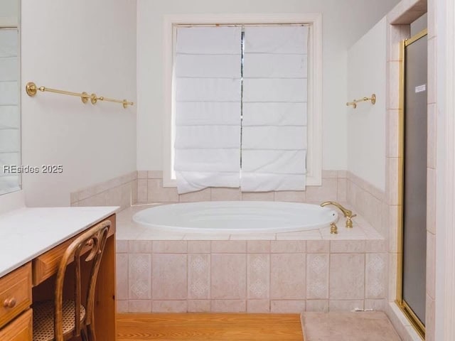 bathroom featuring independent shower and bath and vanity