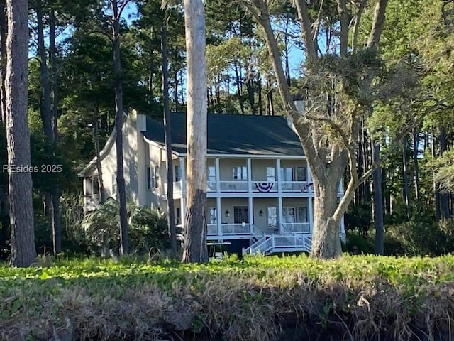 view of front of home with a porch and a balcony