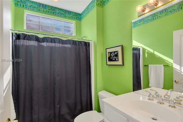 bathroom featuring vanity, toilet, and a shower with shower curtain