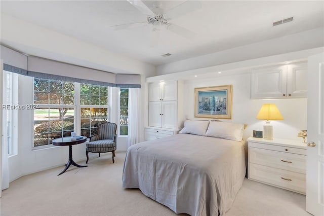 bedroom featuring light colored carpet and ceiling fan