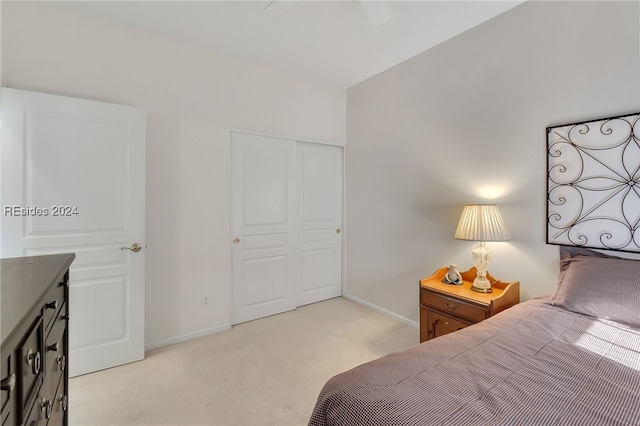 bedroom with light colored carpet and a closet