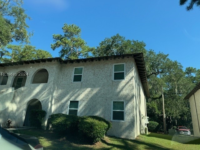 view of home's exterior with a lawn