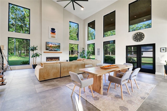 dining space featuring a towering ceiling