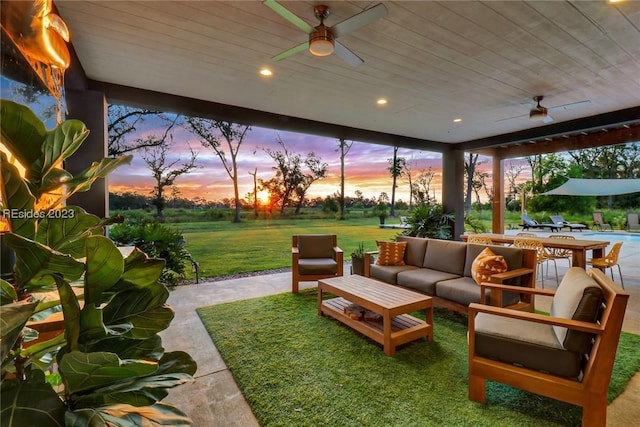 sunroom featuring ceiling fan and wood ceiling