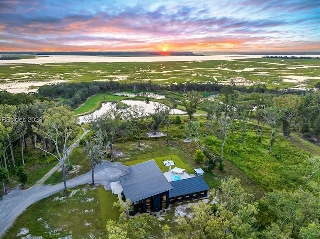 aerial view at dusk with a water view