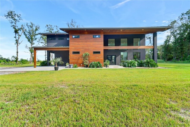 rear view of property featuring a yard