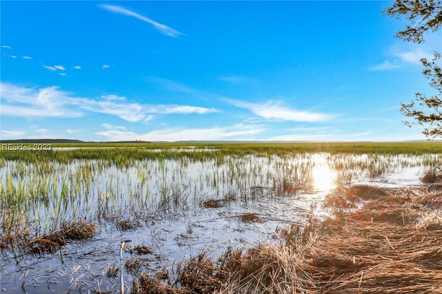 view of snow covered land with a water view