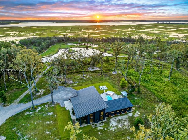 aerial view at dusk with a water view