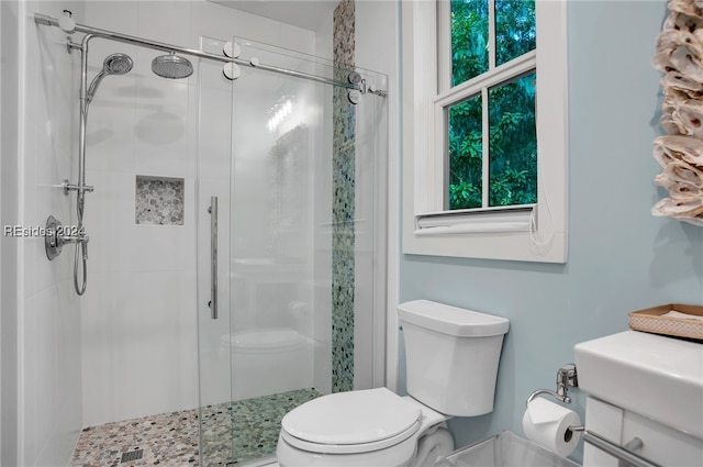 bathroom with toilet and a shower with shower door