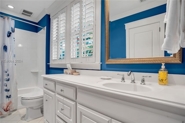 full bathroom featuring crown molding, vanity, tile patterned floors, toilet, and shower / bath combo with shower curtain