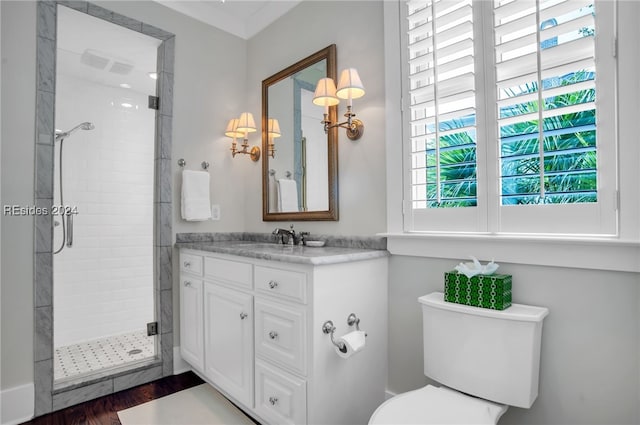 bathroom featuring hardwood / wood-style flooring, vanity, toilet, and a shower with shower door