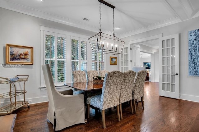 dining area with ornamental molding and dark hardwood / wood-style flooring