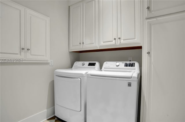 laundry room with cabinets and washer and dryer