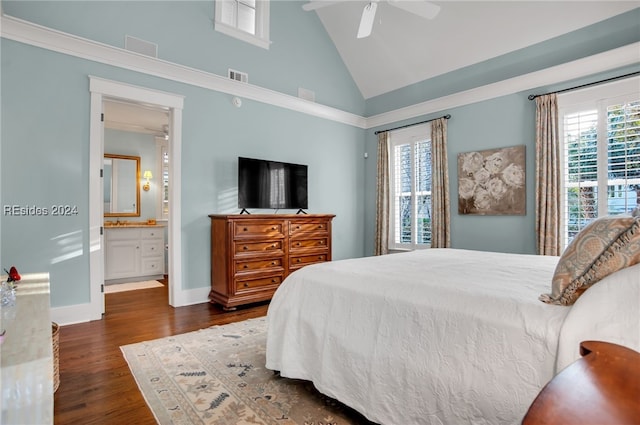 bedroom featuring multiple windows, ensuite bath, dark hardwood / wood-style flooring, and ceiling fan