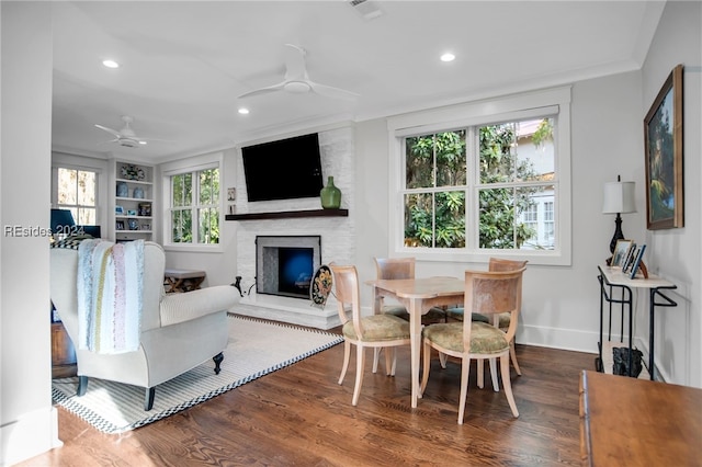 dining area with hardwood / wood-style floors, built in features, a healthy amount of sunlight, and ceiling fan