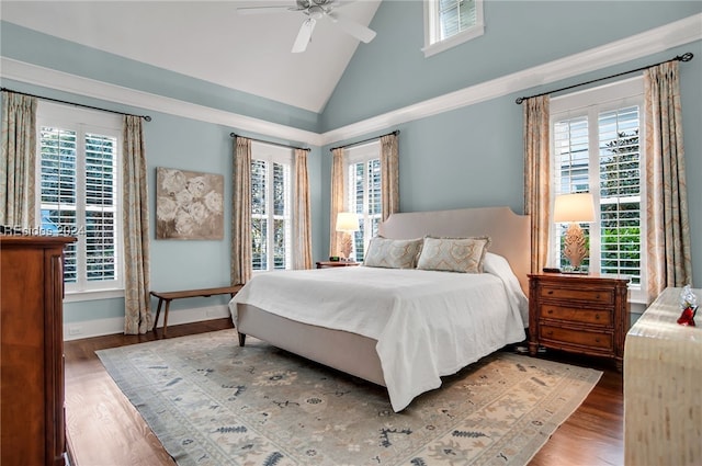 bedroom featuring ceiling fan, wood-type flooring, and high vaulted ceiling