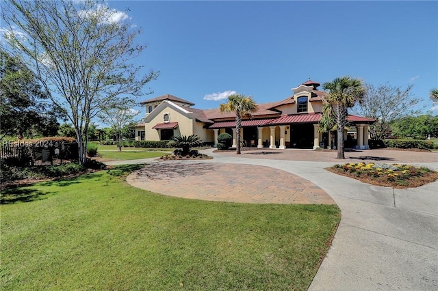 mediterranean / spanish-style house featuring a front yard