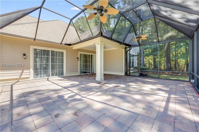 unfurnished sunroom with ceiling fan, lofted ceiling, and ornate columns