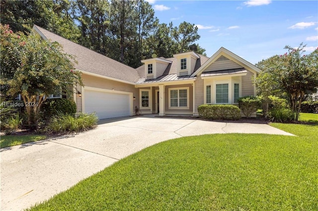 view of front of property featuring a garage and a front lawn