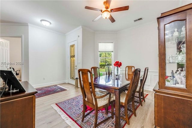 dining space featuring crown molding, light hardwood / wood-style flooring, and ceiling fan