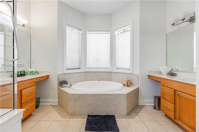 bathroom with vanity, tiled tub, and tile patterned floors