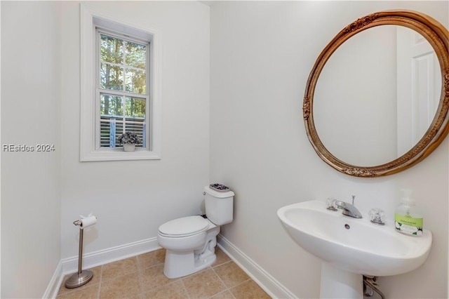 bathroom featuring tile patterned flooring, sink, and toilet