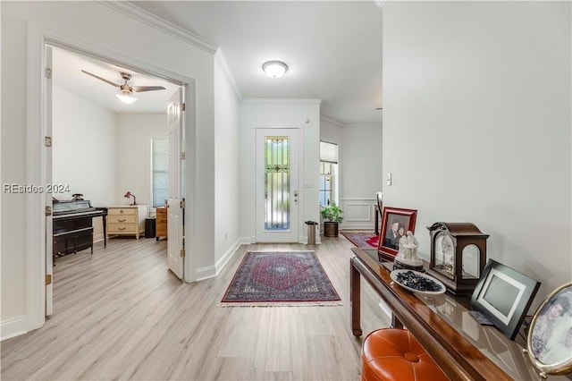 foyer featuring crown molding and light hardwood / wood-style flooring