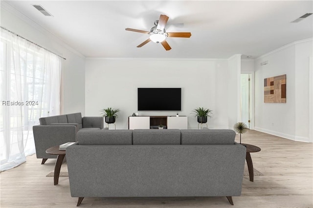 living room featuring crown molding, ceiling fan, and light hardwood / wood-style floors