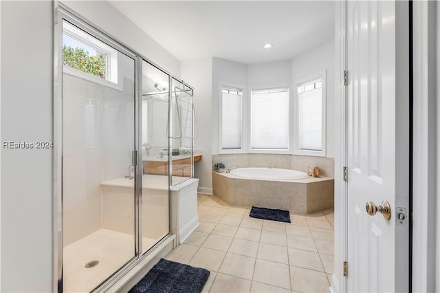 bathroom featuring tile patterned floors and separate shower and tub