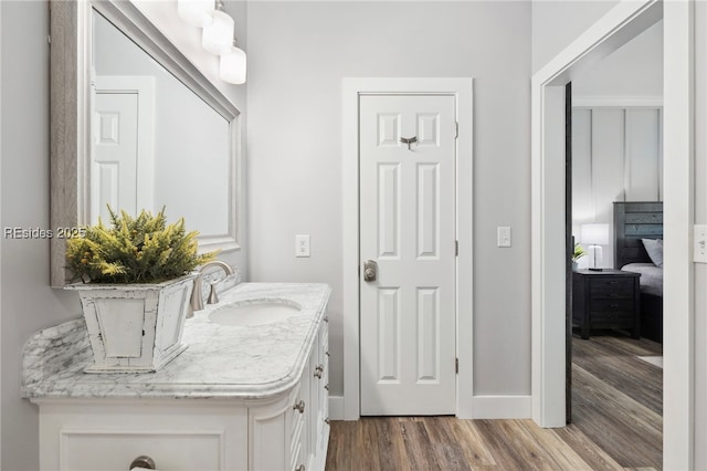 bathroom with hardwood / wood-style flooring and vanity