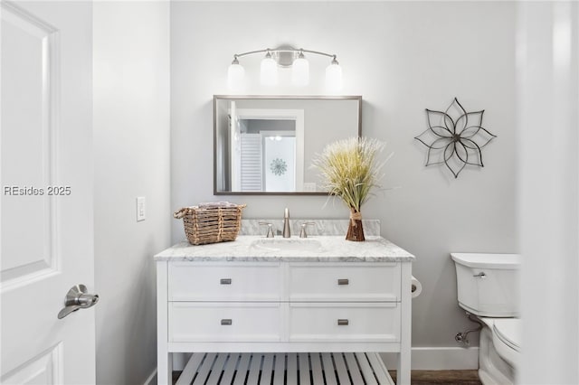 bathroom featuring vanity and toilet