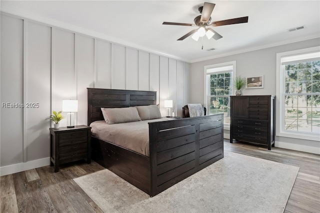 bedroom featuring crown molding, ceiling fan, and hardwood / wood-style flooring