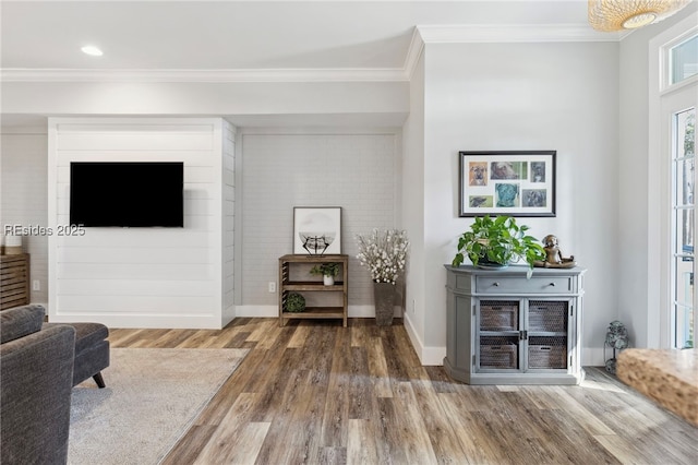 living room featuring crown molding and hardwood / wood-style flooring