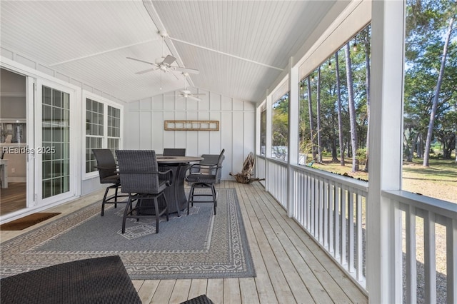 sunroom featuring lofted ceiling and ceiling fan