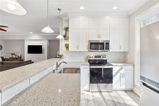 kitchen with white cabinetry, sink, pendant lighting, and stainless steel appliances