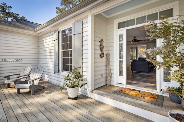 view of exterior entry featuring a wooden deck