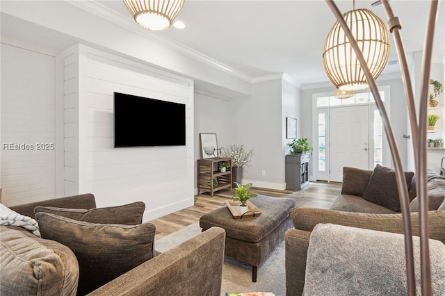 living room featuring hardwood / wood-style flooring and crown molding