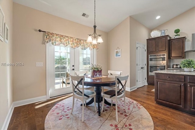 dining space featuring lofted ceiling, a notable chandelier, and dark hardwood / wood-style floors