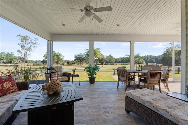 sunroom / solarium featuring ceiling fan and a healthy amount of sunlight