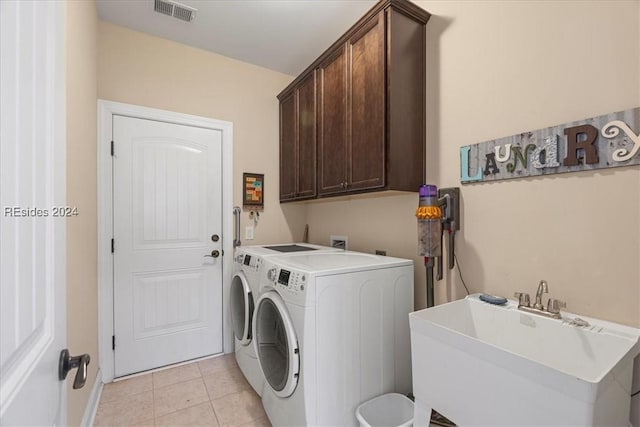 washroom with cabinets, independent washer and dryer, sink, and light tile patterned floors