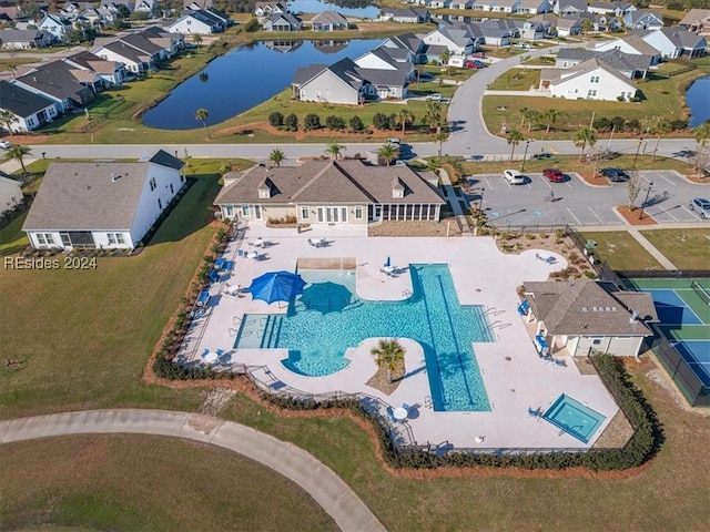 birds eye view of property with a water view