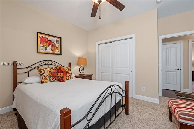 carpeted bedroom with ceiling fan and a closet