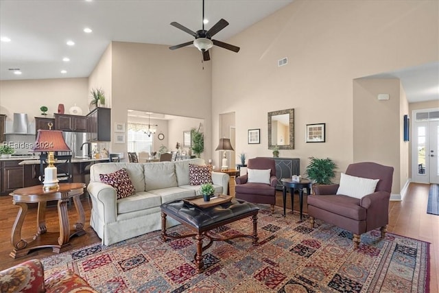 living room featuring ceiling fan, sink, high vaulted ceiling, and hardwood / wood-style floors