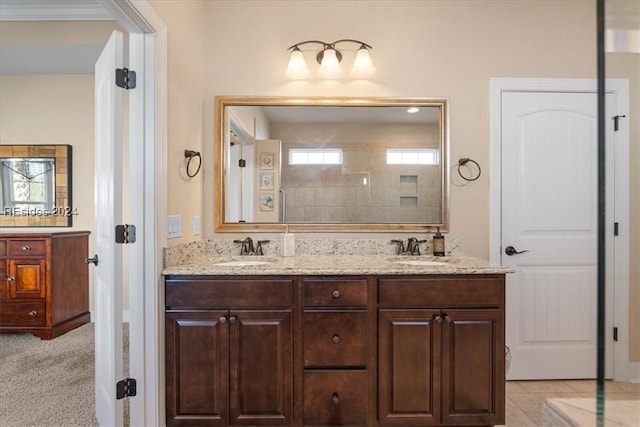 bathroom featuring ornamental molding and vanity